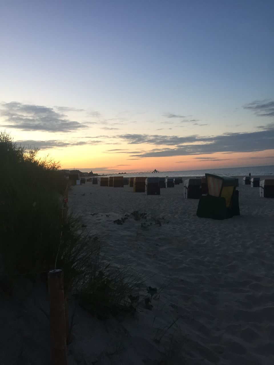 SCENIC VIEW OF BEACH AT SUNSET