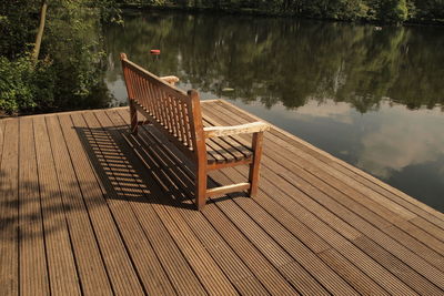 Jetty on lake against trees