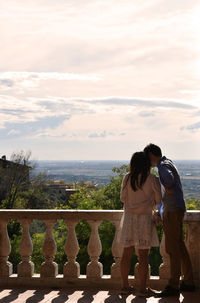 Couple standing against sky in balcony