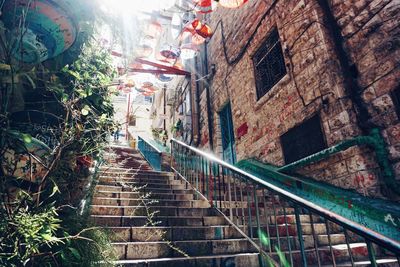 Low angle view of steps amidst buildings