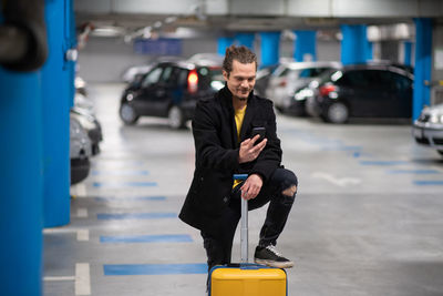 Low angle view of young man standing in city