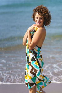 Young woman standing at beach