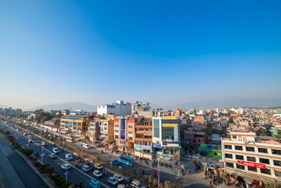 High angle view of buildings against clear blue sky