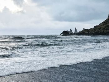 Scenic view of beach against sky
