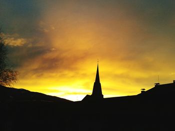 Silhouette of built structure at sunset