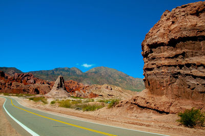 Scenic view of mountains against clear blue sky