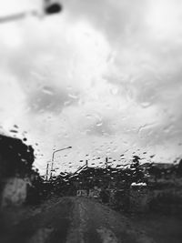 Road seen through wet car windshield