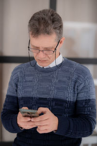 Mid adult man using smart phone