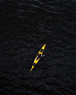 High angle view of yellow kayak floating on sea