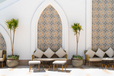 Arabian style terrace exterior with sofas, tables, stools and pillows