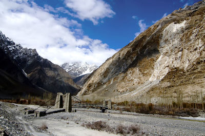 Scenic view of mountains against cloudy sky