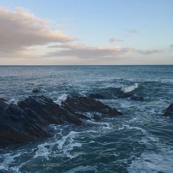 Scenic view of sea against cloudy sky