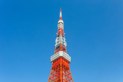 Low angle view of communication tower against blue sky