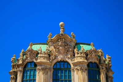 Low angle view of historical building against blue sky