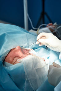 Midsection of doctor examining patient in hospital