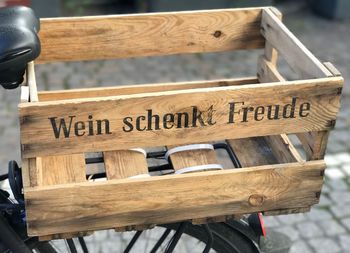 Wooden crate with text on parked bicycle