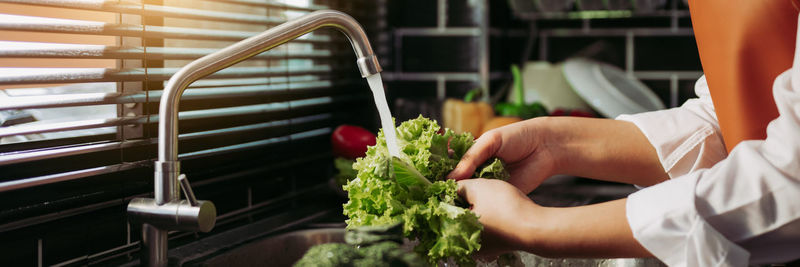 Midsection of man preparing food in kitchen