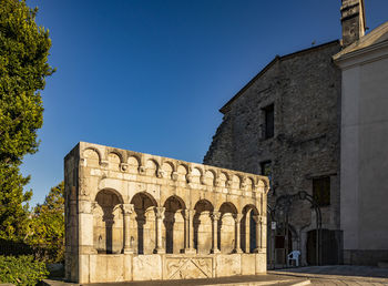 Exterior of old building against clear blue sky