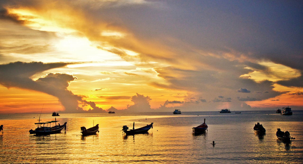 water, sky, sunset, cloud, sea, nautical vessel, transportation, horizon, beauty in nature, nature, dawn, scenics - nature, evening, silhouette, mode of transportation, afterglow, ocean, sun, travel, beach, tranquility, shore, orange color, reflection, travel destinations, land, dramatic sky, tranquil scene, outdoors, wave, horizon over water, vehicle, seascape, sunlight, group of people, idyllic, environment, holiday, boat, coast, vacation, trip, tropical climate, tourism, watercraft