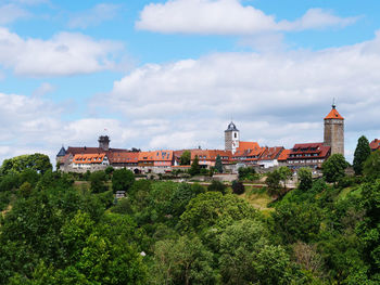 View of trees and buildings against sky