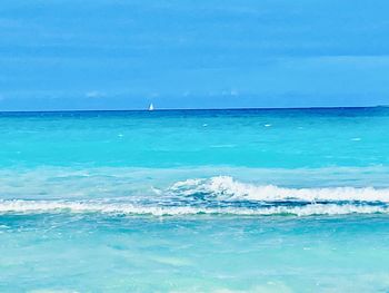 Scenic view of sea against blue sky