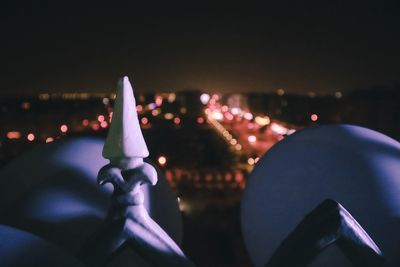 Close-up of illuminated candles against sky at night