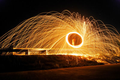 Wire wool against sky at night