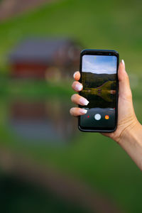 Midsection of man using mobile phone