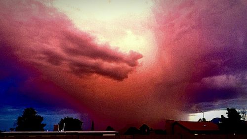 Low angle view of building against cloudy sky