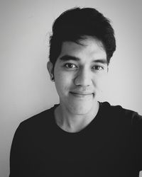 Close-up portrait of young woman over white background