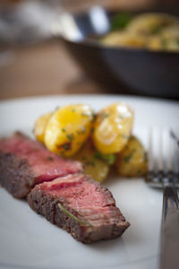 Close-up of steak in plate on table in restaurant