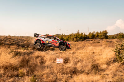 Vintage car on land against sky