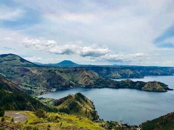 Scenic view of lake and mountains against sky