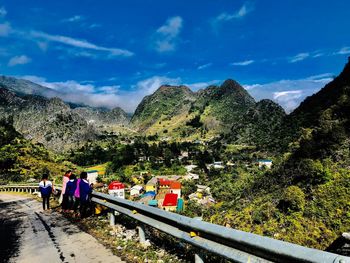 People on mountain road against sky