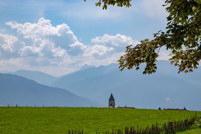 Built structure on field against sky