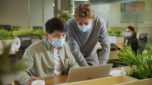 Businessmen wearing mask working at office