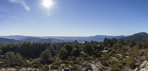 Scenic view of mountains against sky on sunny day