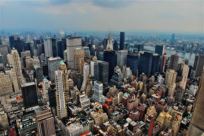 High angle view of modern buildings in city against sky