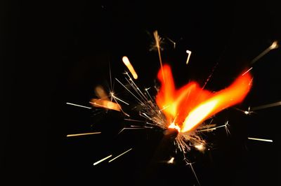 Close-up of illuminated fire against black background