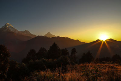 Scenic view of silhouette mountains against sky at sunset