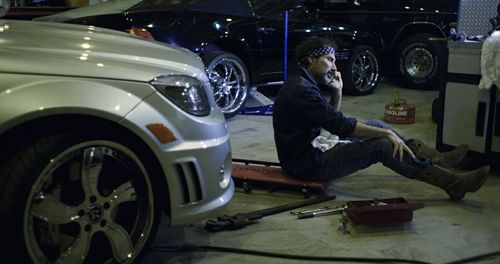 Midsection of man standing in car
