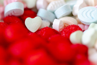 Sweet pills and drops in vibrant various colours. selective focus on heart shape pill. 