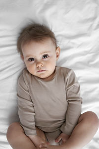 Portrait of cute girl lying on bed