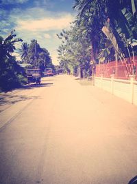 Road amidst trees against sky