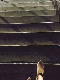 Low section of person standing on tiled floor