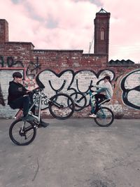 Bicycles on bicycle against sky in city