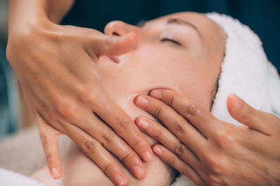 Close-up of woman getting massage therapy at spa
