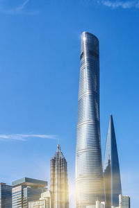 Low angle view of modern buildings against clear blue sky