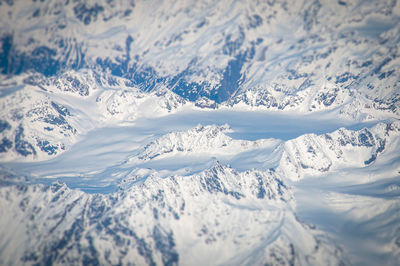Tilt shift effect of glacier of the alps seen from the plane