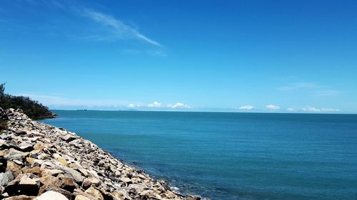 Scenic view of sea against blue sky